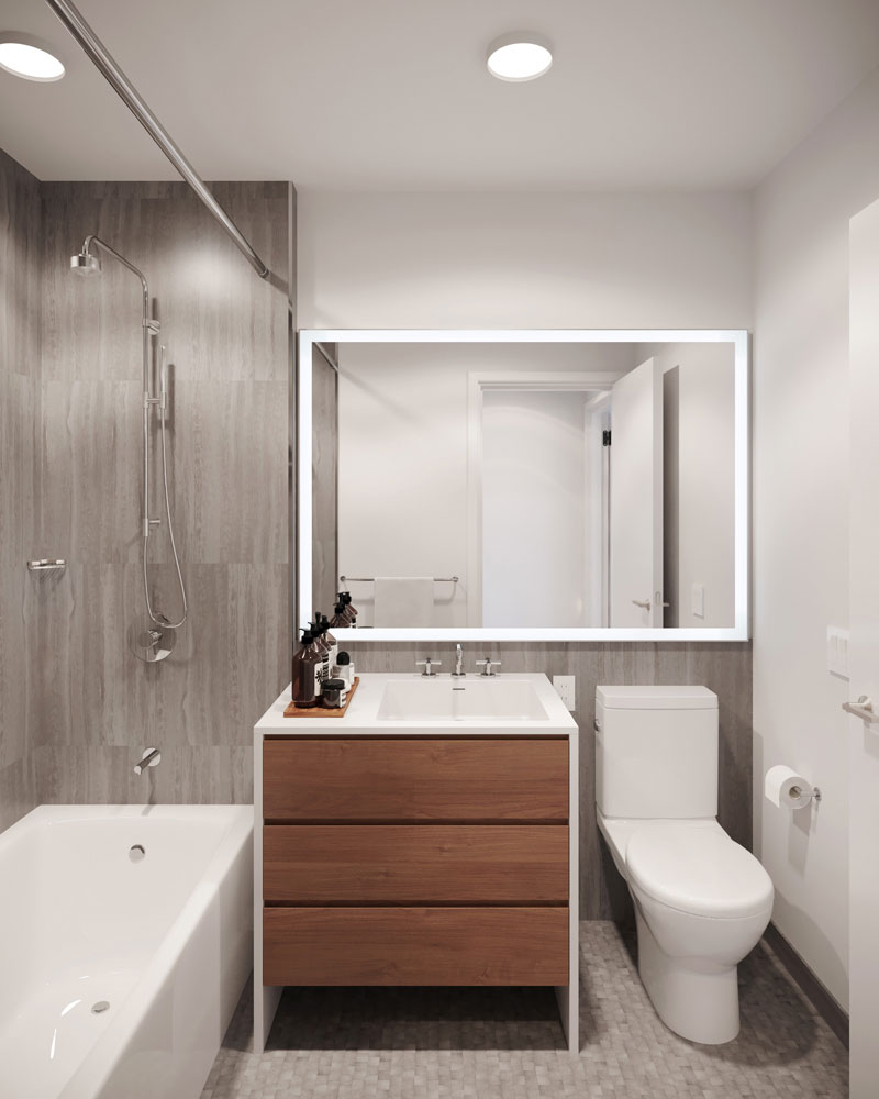 200 W. 60 rental apartment bathroom equipped with marble tile wall and floor, double-height medicine cabinets, and LED Illuminateed Mirrors.